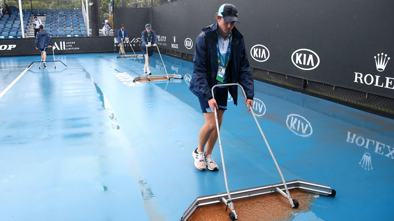 MELBOURNE, AUSTRALIA - JANUARY 23: Staff are seen attempting to clean dirt off the outside courts after being caused by rainfall on day four of the 2020 Australian Open at Melbourne Park on January 23, 2020 in Melbourne, Australia.