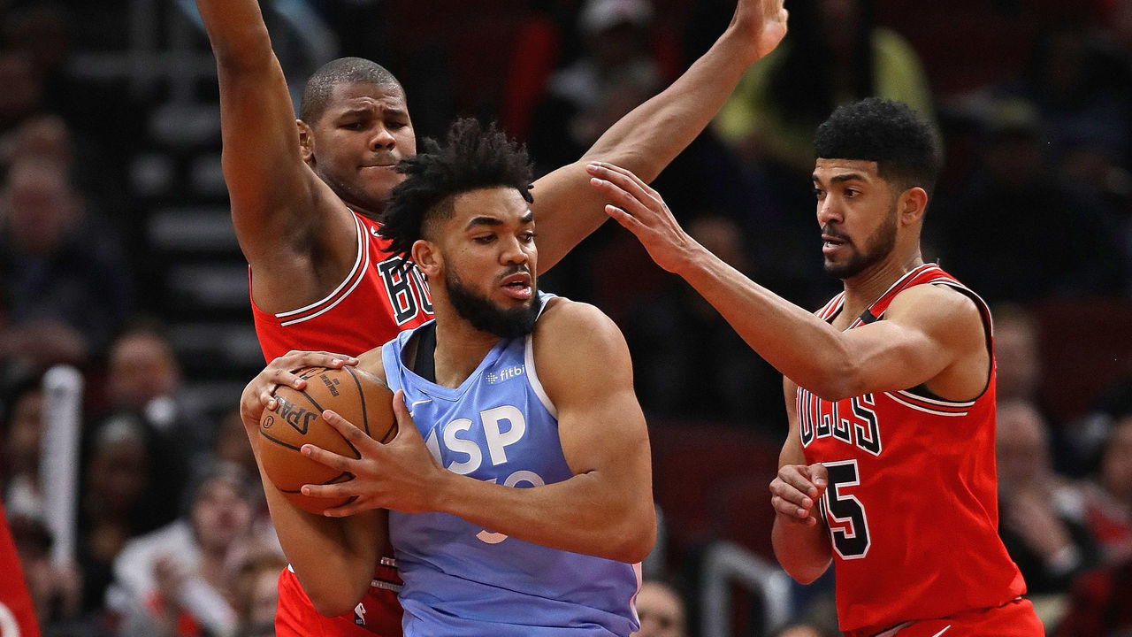 CHICAGO, ILLINOIS - JANUARY 22: Karl-Anthony Towns #32 of the Minnesota Timberwolves is boxed in by Cristiano Felicio #6 (L) and Chandler Hutchison #15 of the Chicago Bulls at the United Center on January 22, 2020 in Chicago, Illinois. The Bulls defeated the Timberwolves 117-110.