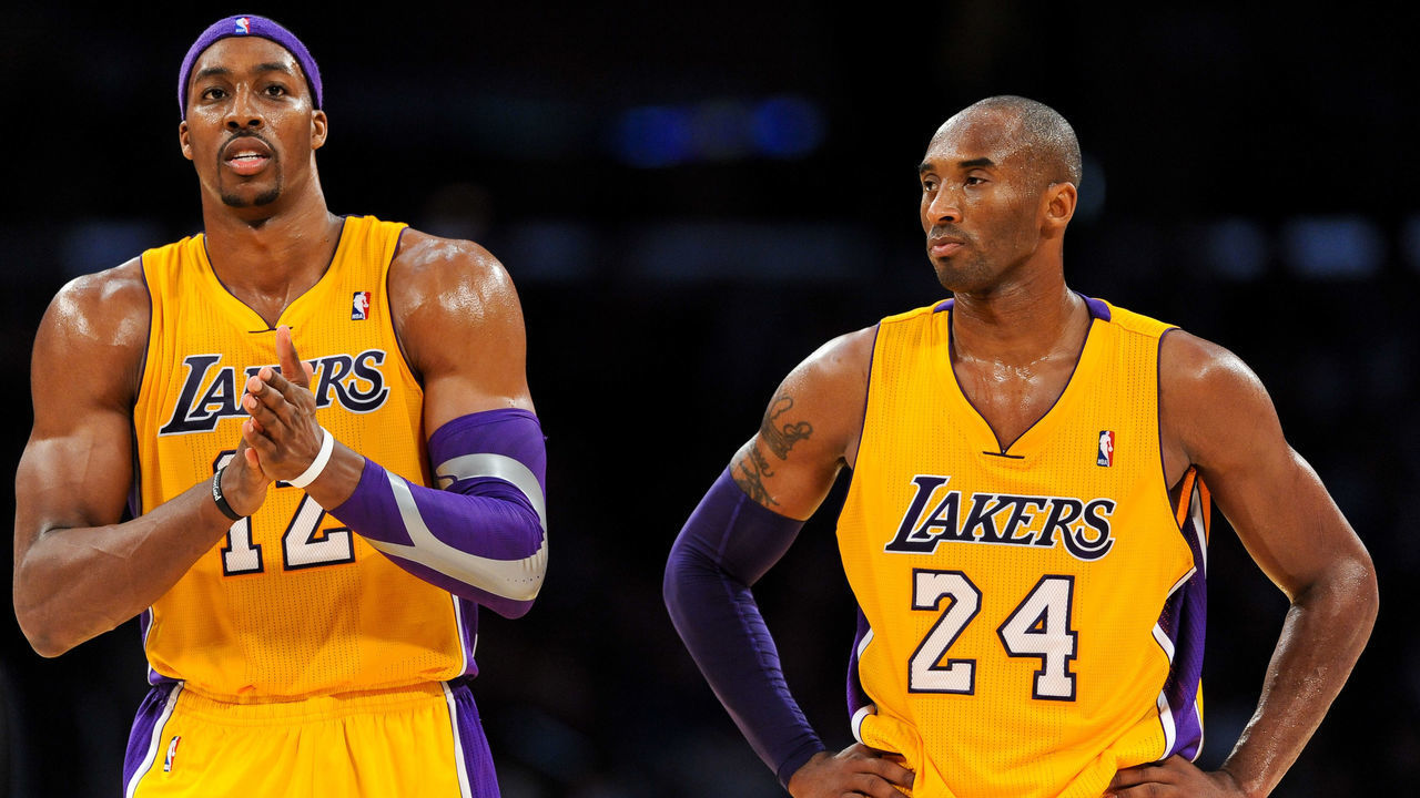 LOS ANGELES, CA - NOVEMBER 20: Dwight Howard #12 and Kobe Bryant #24 of the Los Angeles Lakers wait to resume action against the Brooklyn Nets at Staples Center on November 20, 2012 in Los Angeles, California. NOTE TO USER: User expressly acknowledges and agrees that, by downloading and/or using this Photograph, user is consenting to the terms and conditions of the Getty Images License Agreement. Mandatory Copyright Notice: Copyright 2012 NBAE