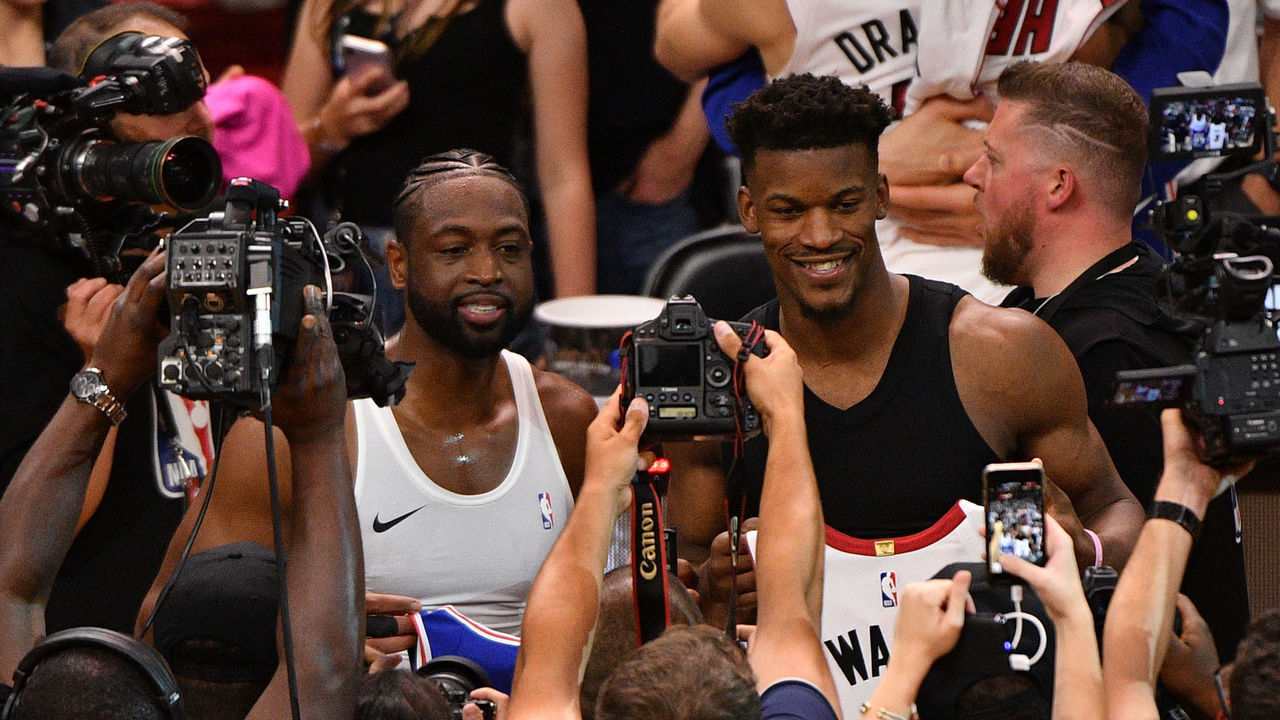MIAMI, FL - APRIL 09: Dwyane Wade #3 of the Miami Heat and Jimmy Butler #23 of the Philadelphia 76ers swap jerseys after the final regular season home game at American Airlines Arena on April 09, 2019 in Miami, Florida.