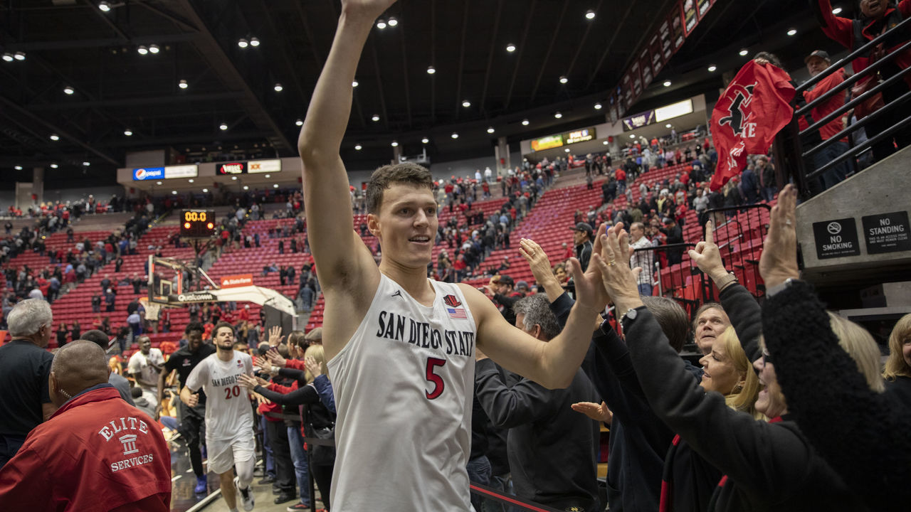 SAN DIEGO, CA - JANUARY 21: San Diego State University Aztecs forward Yanni Wetzell (5) high fives fans after the game between the Wyoming Cowboys and the San Diego State Aztecs on January 21, 2020 at the Steve Fisher Court at Viejas Arena in San Diego, California.