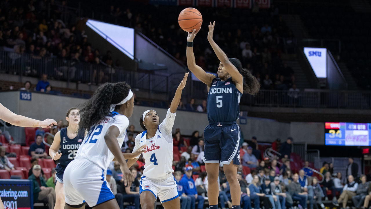 DALLAS, TX - JANUARY 05: UConn Huskies guard Crystal Dangerfield (#5) takes a jump shot over SMU Mustangs guard Amber Bacon (#4) during the American Athletic Conference womens college basketball game between the UConn Huskies and the SMU Mustangs on January 05, 2020 at Moody Coliseum in Dallas, Texas.