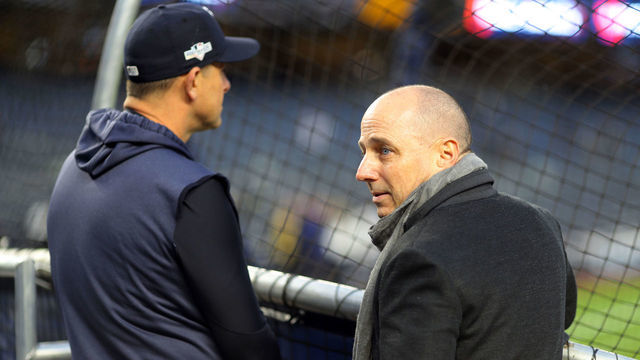 BRONX, NY - OCTOBER 17: Manager Aaron Boone #17 of the New York Yankees watches batting practice as General Manager Brian Cashman looks on prior to Game 4 of the ALCS between the Houston Astros and the New York Yankees at Yankee Stadium on Thursday, October 17, 2019 in the Bronx borough of New York City.
