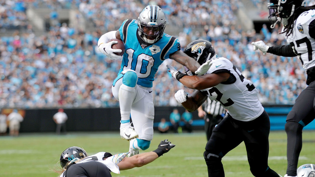 CHARLOTTE, NC - OCTOBER 06: Carolina Panthers wide receiver Curtis Samuel (10) leaps over Jacksonville Jaguars long snapper Matthew Orzech (46) as another defender comes in for a hit in the game between the Jacksonville Jaguars and the Carolina Panthers on October 06, 2019 at Bank of America Stadium in Charlotte,NC.