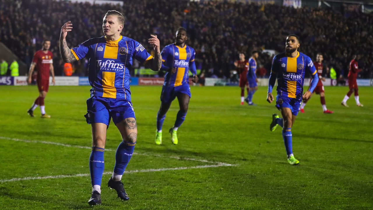 SHREWSBURY, ENGLAND - JANUARY 26: Jason Cummings of Shrewsbury Town celebrates after scoring a goal to make it 1-2 during the FA Cup Fourth Round match between Shrewsbury Town and Liverpool at New Meadow on January 26, 2020 in Shrewsbury, England.