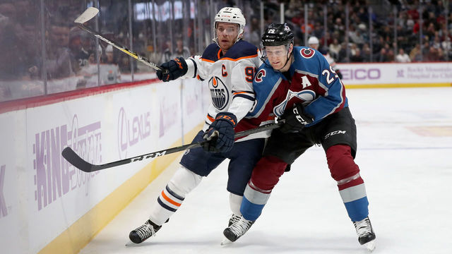 DENVER, COLORADO - NOVEMBER 27: Connor McDavid #97 of the Edmonton Oilers fights for the puck against Nathan MacKinnon #29 of the Colorado Avalanche in the first period at the Pepsi Center on November 27, 2019 in Denver, Colorado.