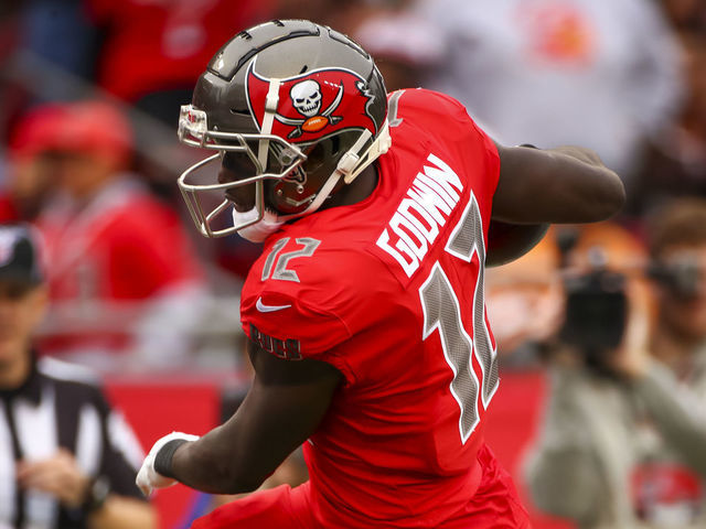 TAMPA, FLORIDA - NOVEMBER 17: Chris Godwin #12 of the Tampa Bay Buccaneers pushes his way into the end zone to score during the third quarter of the game against the New Orleans Saints on November 17, 2019 at Raymond James Stadium in Tampa, Florida.