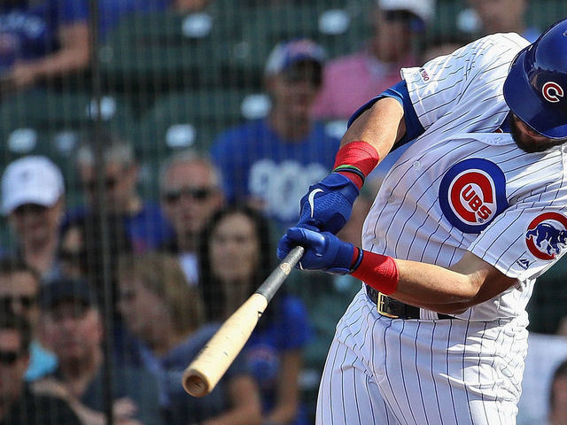 CHICAGO, ILLINOIS - AUGUST 30: Kyle Schwarber #12 of the Chicago Cubs hits a solo home run in the 8th inning against the Milwaukee Brewers at Wrigley Field on August 30, 2019 in Chicago, Illinois. The Cubs defeated the Brewers 7-1.
