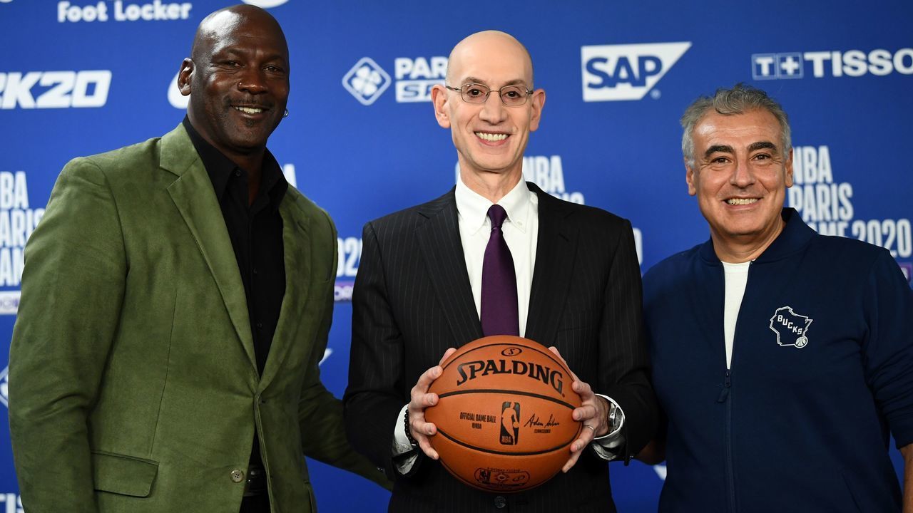 Former NBA star and owner of Charlotte Hornets team Michael Jordan (L) poses with NBA commissioner Adam Silver (C) and Marc Lasry co-owner of the Milwaukee Bucks (R) at a press conference ahead of the NBA basketball match between Milwaukee Bucks and Charlotte Hornets at The AccorHotels Arena in Paris on January 24, 2020.