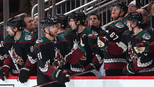 GLENDALE, ARIZONA - JANUARY 12: Taylor Hall #91 of the Arizona Coyotes celebrates with teammates on the bench after scoring against the Pittsburgh Penguins during the second period of the NHL game at Gila River Arena on January 12, 2020 in Glendale, Arizona.