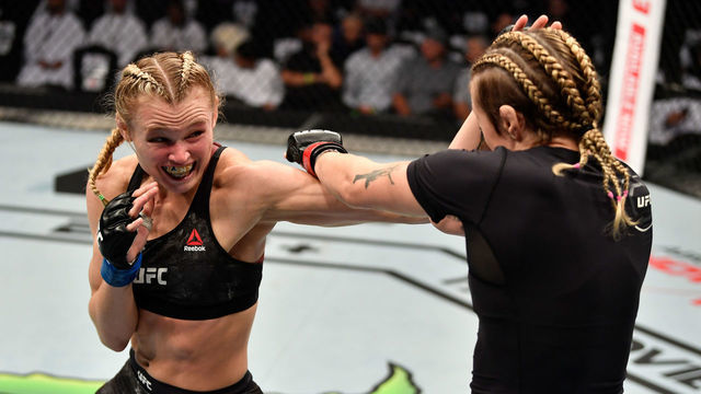 ABU DHABI, UNITED ARAB EMIRATES - SEPTEMBER 07: (L-R) Andrea Lee punches Joanne Calderwood of United Kingdom in their women's flyweight bout during UFC 242 at The Arena on September 7, 2019 in Yas Island, Abu Dhabi, United Arab Emirates.