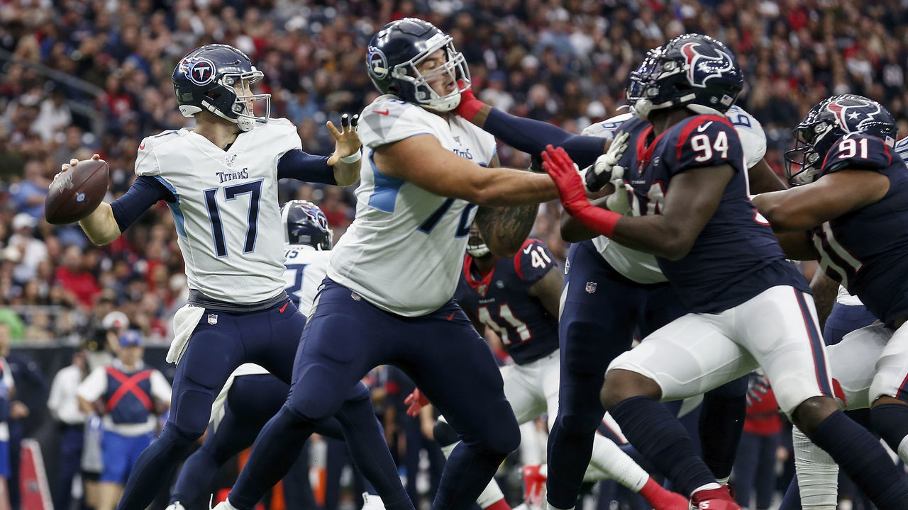 HOUSTON, TX - DECEMBER 29: Ryan Tannehill #17 of the Tennessee Titans looks to pass under pressure by Charles Omenihu #94 of the Houston Texans in the first half at NRG Stadium on December 29, 2019 in Houston, Texas.
