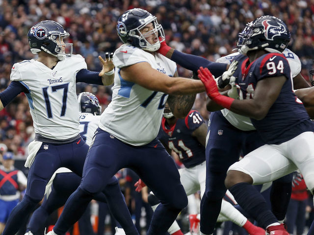 HOUSTON, TX - DECEMBER 29: Ryan Tannehill #17 of the Tennessee Titans looks to pass under pressure by Charles Omenihu #94 of the Houston Texans in the first half at NRG Stadium on December 29, 2019 in Houston, Texas.