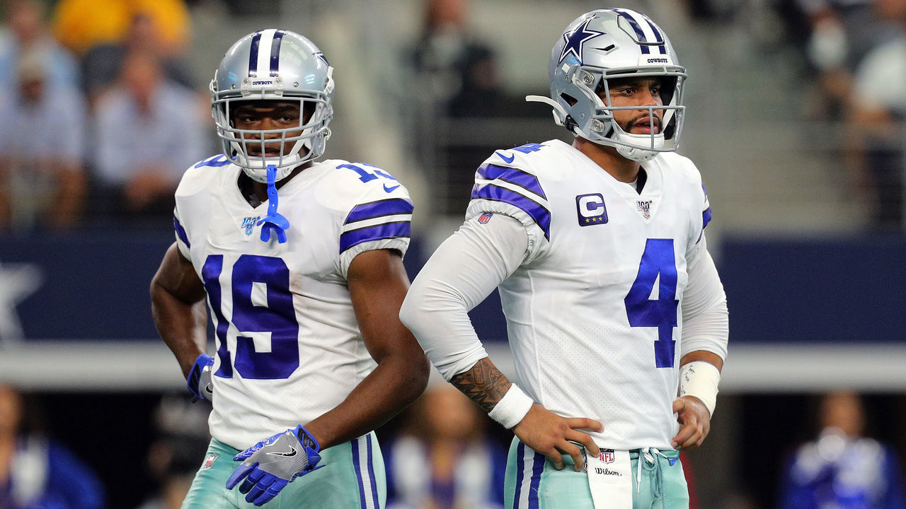 ARLINGTON, TEXAS - OCTOBER 06: Amari Cooper #19 and Dak Prescott #4 of the Dallas Cowboys stand on the field in the first quarter against the Green Bay Packers at AT&T Stadium on October 06, 2019 in Arlington, Texas.