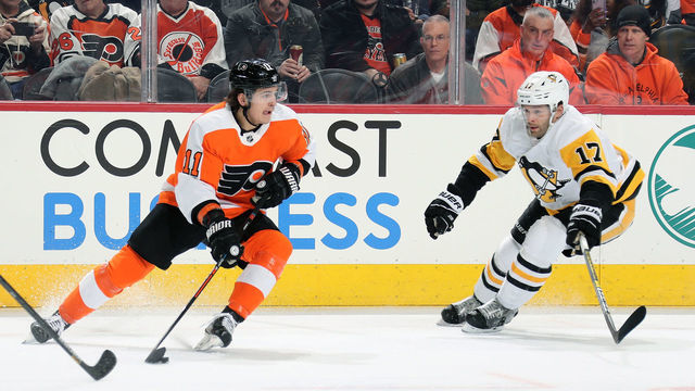 PHILADELPHIA, PA - JANUARY 21: Travis Konecny #11 of the Philadelphia Flyers skates the puck against Bryan Rust #17 of the Pittsburgh Penguins on January 21, 2020 at the Wells Fargo Center in Philadelphia, Pennsylvania.