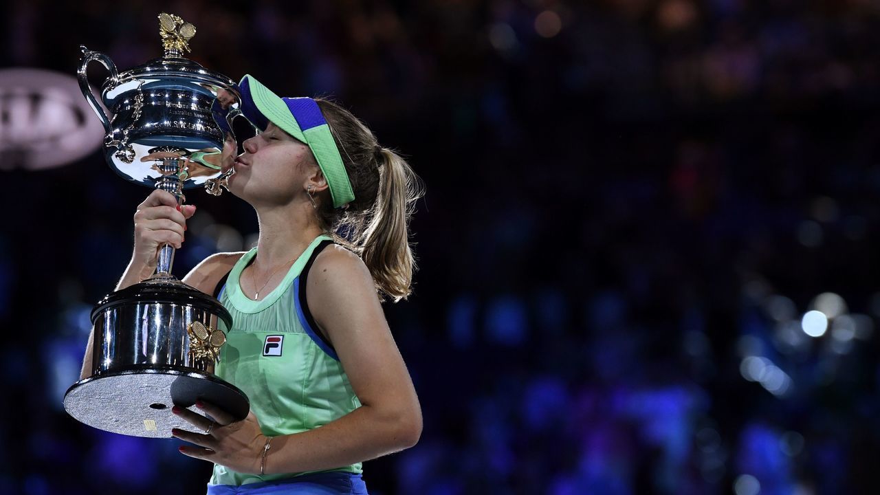 Sofia Kenin of the US kisses the Daphne Akhurst Memorial Cup after winning against Spain's Garbine Muguruza in their women's singles final match on day thirteen of the Australian Open tennis tournament in Melbourne on February 1, 2020.
