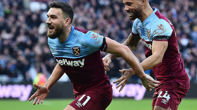 West Ham United's Scottish midfielder Robert Snodgrass (L) celebrates scoring his team's second goal with West Ham United's English defender Ryan Fredericks during the English Premier League football match between West Ham United and Brighton and Hove Albion at The London Stadium, in east London on February 1, 2020.