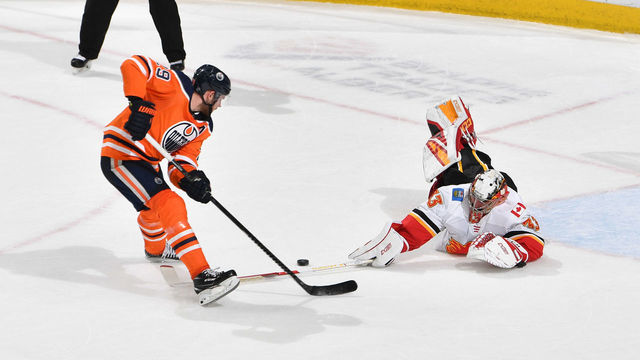 EDMONTON, AB - JANUARY 29: Leon Draisaitl #29 of the Edmonton Oilers is poke checked by David Rittich #33 the Calgary Flames in the shoot out on January 29, 2020, at Rogers Place in Edmonton, Alberta, Canada.