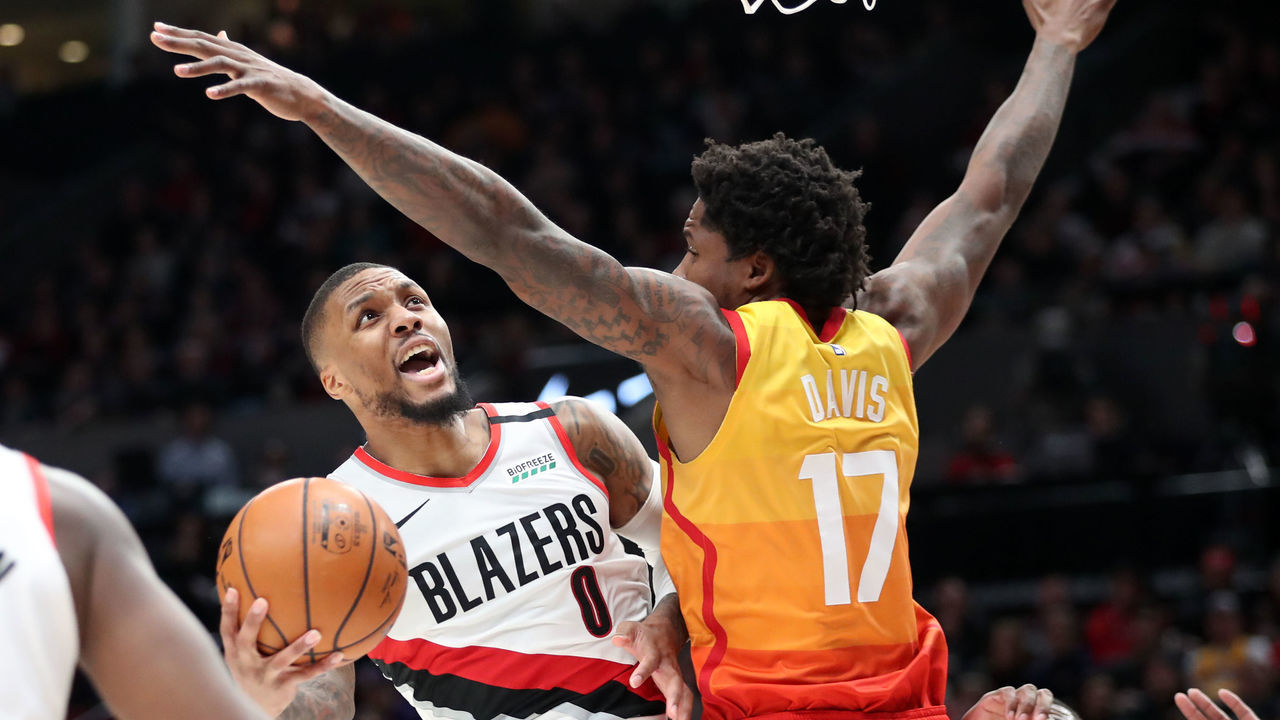 PORTLAND, OREGON - FEBRUARY 01: Damian Lillard #0 of the Portland Trail Blazers takes a shot against Ed Davis #17 of the Utah Jazz in the fourth quarter during their game at Moda Center on February 01, 2020 in Portland, Oregon.