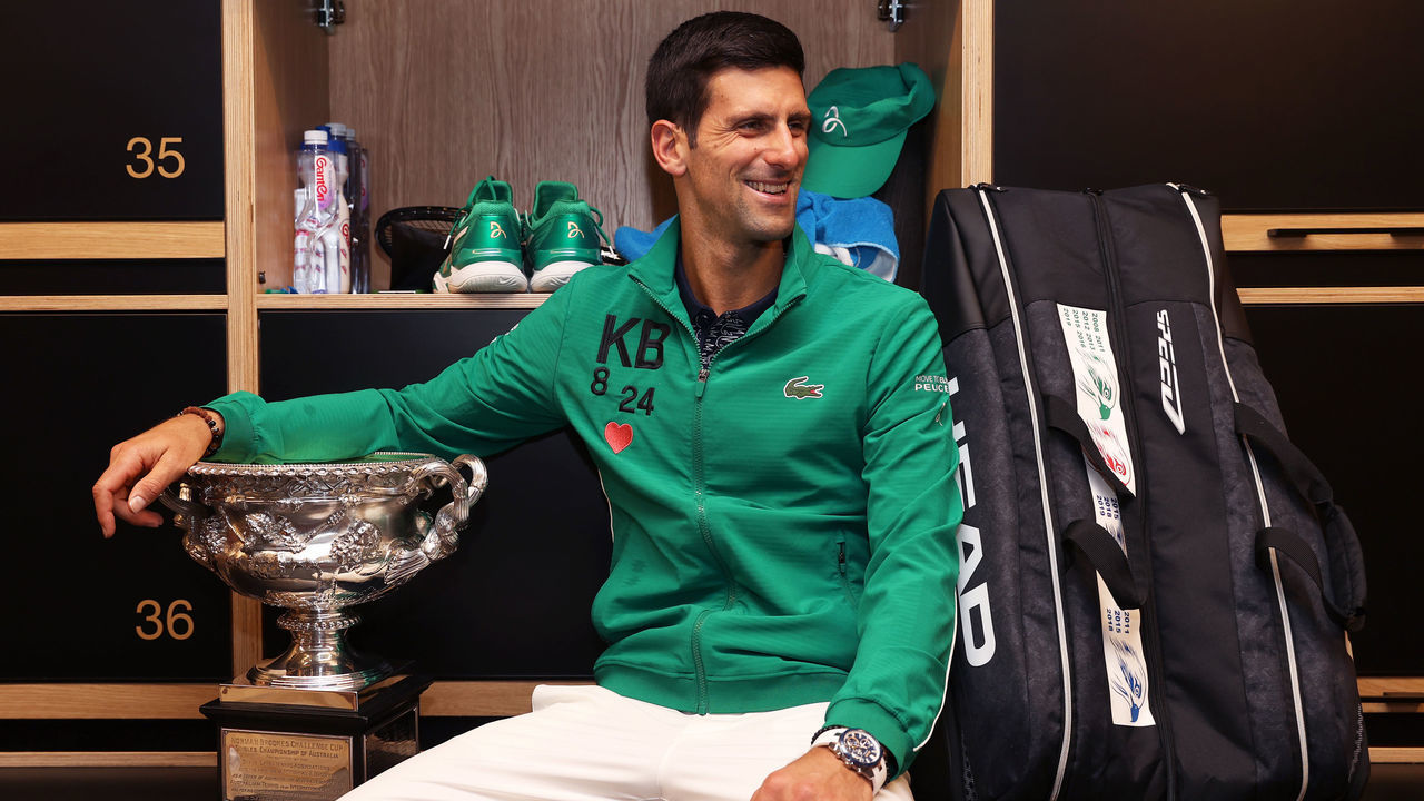 MELBOURNE, AUSTRALIA - FEBRUARY 03: Novak Djokovic of Serbia poses with the Norman Brookes Challenge Cup in the locker room after winning the Men's Singles Final against Dominic Thiem of Austria on day fourteen of the 2020 Australian Open at Melbourne Park on February 03, 2020 in Melbourne, Australia.