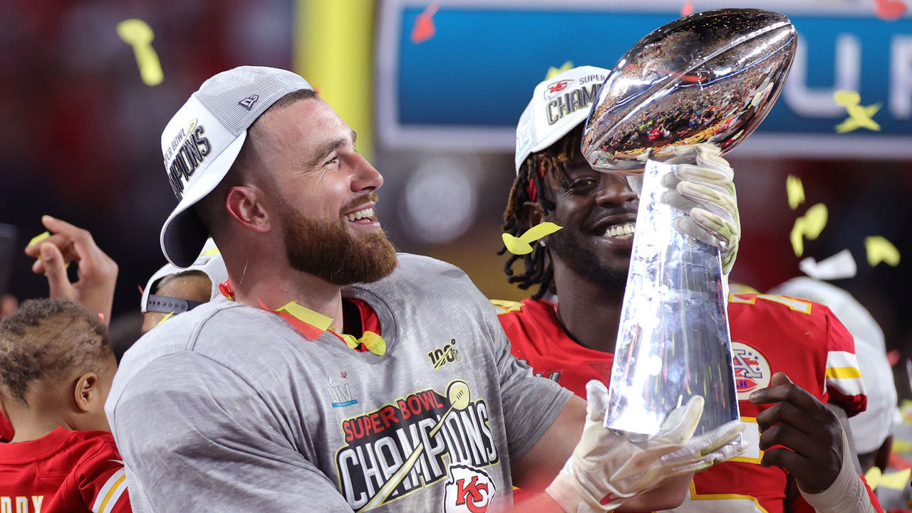 MIAMI, FLORIDA - FEBRUARY 02: Travis Kelce #87 of the Kansas City Chiefs raises the Vince Lombardi Trophy after defeating the San Francisco 49ers 31-20 in Super Bowl LIV at Hard Rock Stadium on February 02, 2020 in Miami, Florida.
