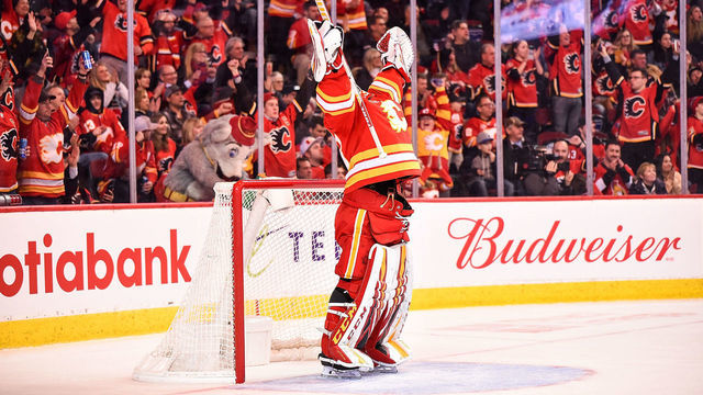 CALGARY, AB - NOVEMBER 30: Calgary Flames Goalie David Rittich (33) raises his arms in celebration following a goal by his team during the third period of an NHL game where the Calgary Flames hosted the Ottawa Senators on November 30, 2019, at the Scotiabank Saddledome in Calgary, AB.