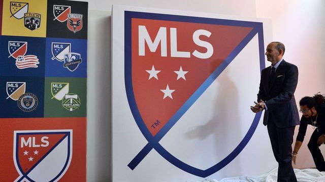 Major League Soccer (MLS) commissioner Don Garber unveils the new MLS logo during an event in New York on September 18. 2014. MLS unveiled the new logo ahead of its 20th season. AFP PHOTO/Jewel Samad