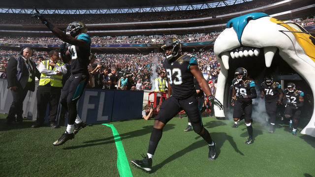 Jacksonville Jaguars players run out for the start of the NFL International Series match at Wembley Stadium, London.