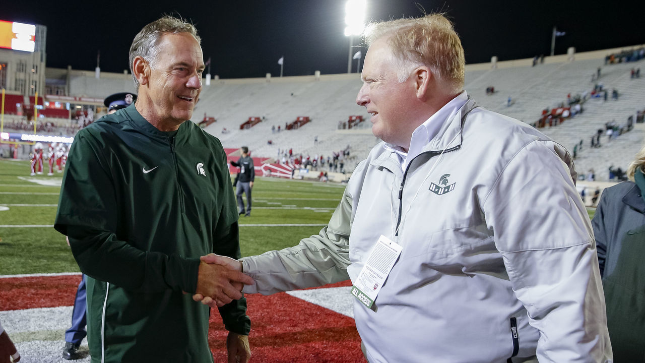 BLOOMINGTON, IN - SEPTEMBER 22: Head coach Mark Dantonio of the Michigan State Spartans speaks to Michigan State Spartans athletics director Bill Beekman following the game against the Indiana Hoosiers at Memorial Stadium on September 22, 2018 in Bloomington, Indiana.