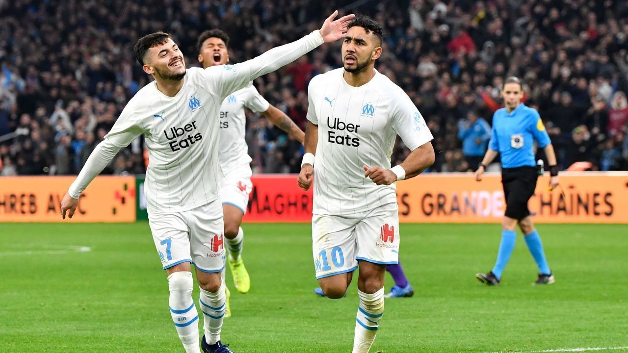 Marseille's French midfielder Dimitri Payet (R) is congratulated by Marseille's Serbian forward Nemanja Radonjic (L) after scoring a goal during the French L1 football match between Olympique de Marseille (OM) and Toulouse Football Club (TFC) at the Velodrome Stadium in Marseille, southern France, on February 8, 2020.