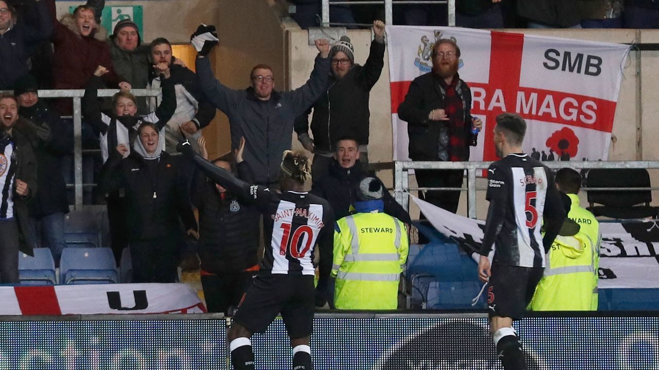 Newcastle United's French midfielder Allan Saint-Maximin (L) celebrates after scoring their third goal during the FA Cup fourth round replay football match between Oxford United and Newcastle United at the Kassam Stadium in Oxford, west of London, on February 4, 2020.