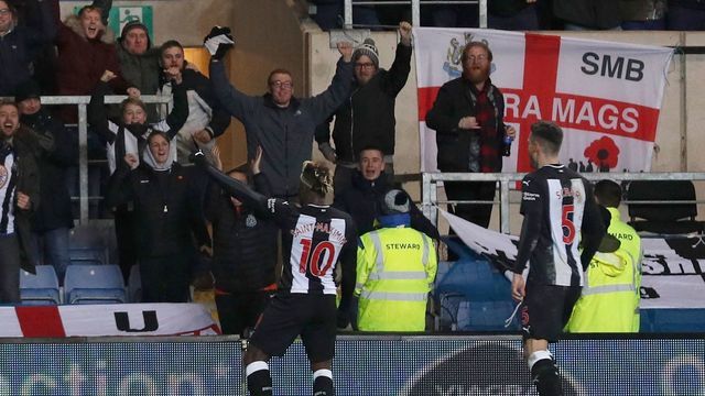 Newcastle United's French midfielder Allan Saint-Maximin (L) celebrates after scoring their third goal during the FA Cup fourth round replay football match between Oxford United and Newcastle United at the Kassam Stadium in Oxford, west of London, on February 4, 2020.