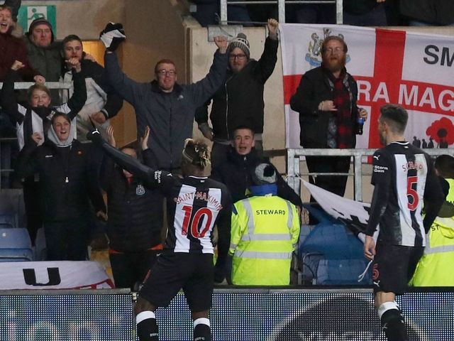 Newcastle United's French midfielder Allan Saint-Maximin (L) celebrates after scoring their third goal during the FA Cup fourth round replay football match between Oxford United and Newcastle United at the Kassam Stadium in Oxford, west of London, on February 4, 2020.