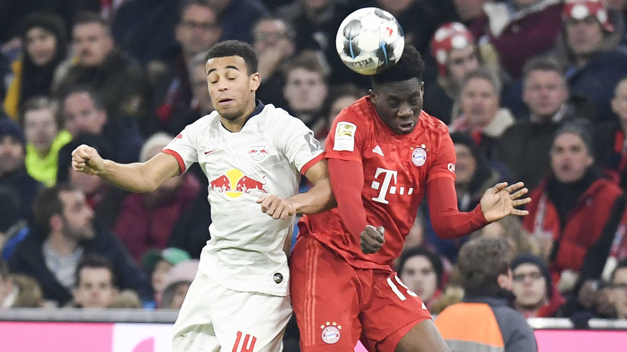 Bayern Munich's Canadian midfielder Alphonso Davies (R) and Leipzig's US midfielder Tyler Adams vie for the ball during the German first division Bundesliga football match FC Bayern Munich v RB Leipzig in Munich, southern Germany, on February 9, 2020.