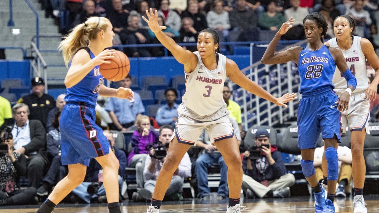 STORRS, CT - NOVEMBER 28: Connecticut Huskies Guard / Forward Megan Walker (3) defends against DePaul Blue Demons Guard Kelly Campbell (20) dribbling the ball with DePaul Blue Demons Forward Chante Stonewall (22) behind her during the first half of the DePaul Blue Demons versus the Connecticut Huskies on November 28, 2018, at the XL Center in Hartford, CT.