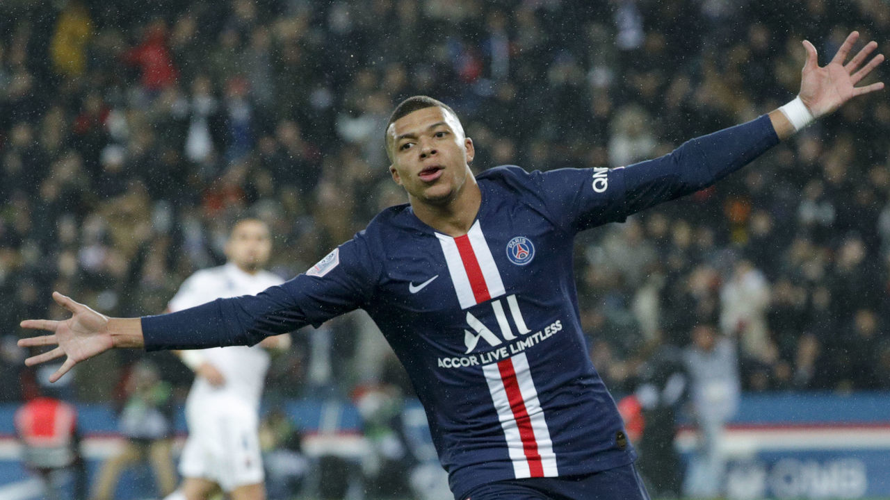 Paris Saint-Germain's French forward Kylian Mbappe celebrates after socring a goal during the French L1 football match between Paris Saint-Germain (PSG) and Lyon (OL) at the Parc des Princes stadium in Paris, on February 9, 2020.