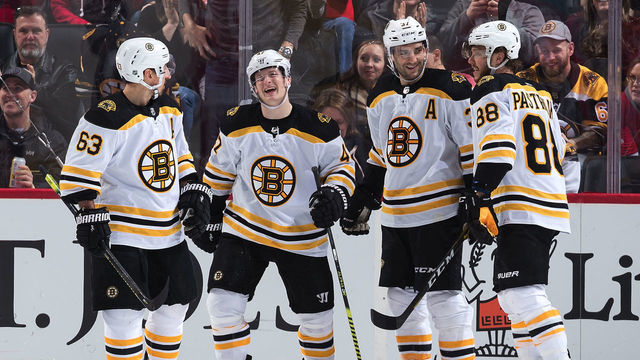 DETROIT, MI - FEBRUARY 09: Torey Krug #47 of the Boston Bruins celebrates his third period goal with teammates Brad Marchand #63, Patrice Bergeron #37 and David Pastrnak #88 during an NHL game against the Detroit Red Wings at Little Caesars Arena on February 9, 2020 in Detroit, Michigan.