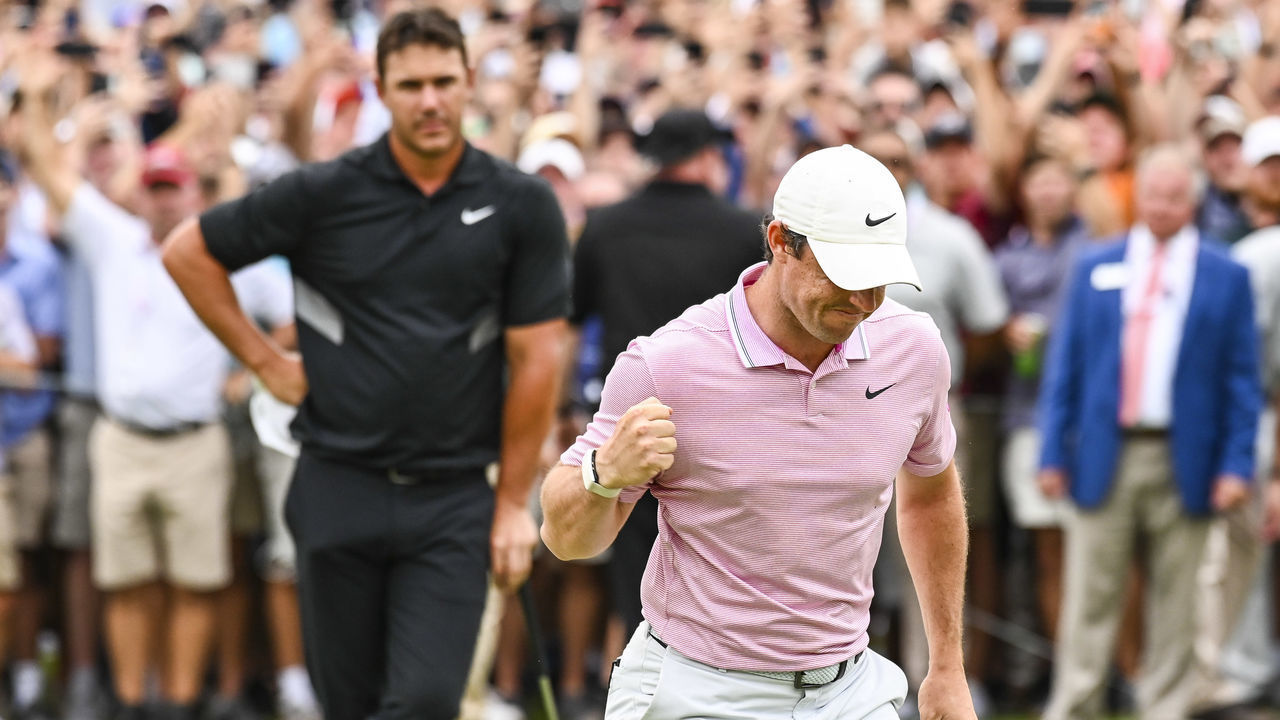 ATLANTA, GA - AUGUST 25: Rory McIlroy of Northern Ireland celebrates and pumps his fist after making a birdie to clinch a four stoke victory on the 18th hole green as Brooks Koepka looks on during the final round of the TOUR Championship, the final event of the FedExCup Playoffs, at East Lake Golf Club on August 25, 2019 in Atlanta, Georgia.
