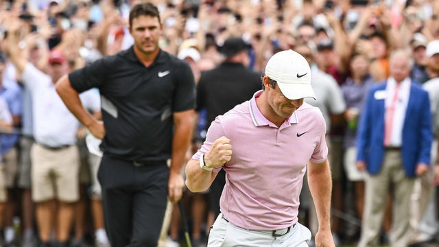 ATLANTA, GA - AUGUST 25: Rory McIlroy of Northern Ireland celebrates and pumps his fist after making a birdie to clinch a four stoke victory on the 18th hole green as Brooks Koepka looks on during the final round of the TOUR Championship, the final event of the FedExCup Playoffs, at East Lake Golf Club on August 25, 2019 in Atlanta, Georgia.