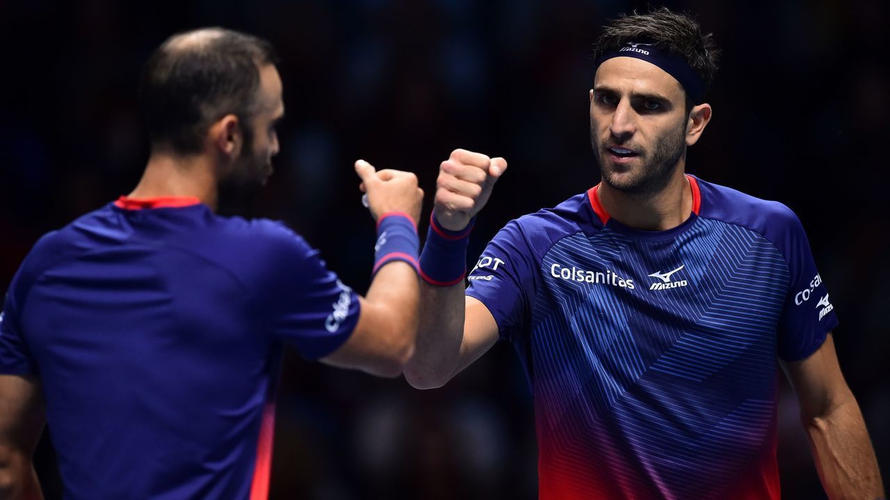 Colombia's Juan Sebastian Cabal (L) and Colombia's Robert Farah chat as they return against Germany's Kevin Krawietz and Germany's Andreas Mies during their men's doubles round-robin match on day six of the ATP World Tour Finals tennis tournament at the O2 Arena in London on November 15, 2019.