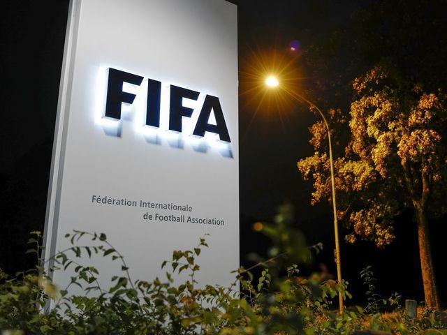 A sign of the FIFA is seen at the entrance of the world football's governing body headquarters on October 13, 2016 in Zurich. / AFP / FABRICE COFFRINI
