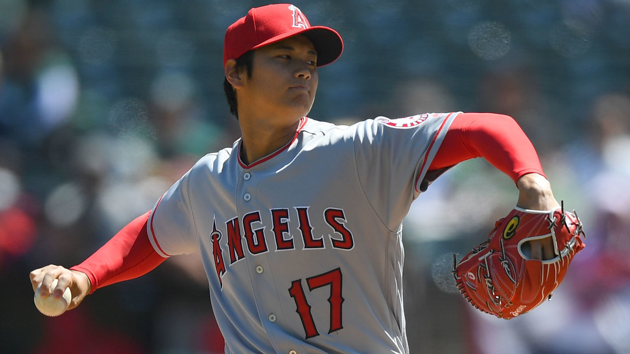 OAKLAND, CA - APRIL 01: Shohei Ohtani #17 of the Los Angeles Angels of Anaheim pitches in the bottom of the first inning of his Major League pitching debut against the Oakland Athletics at Oakland Alameda Coliseum on April 1, 2018 in Oakland, California.