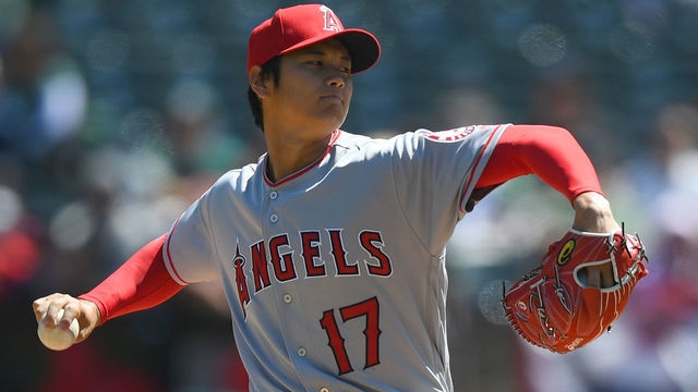 OAKLAND, CA - APRIL 01: Shohei Ohtani #17 of the Los Angeles Angels of Anaheim pitches in the bottom of the first inning of his Major League pitching debut against the Oakland Athletics at Oakland Alameda Coliseum on April 1, 2018 in Oakland, California.