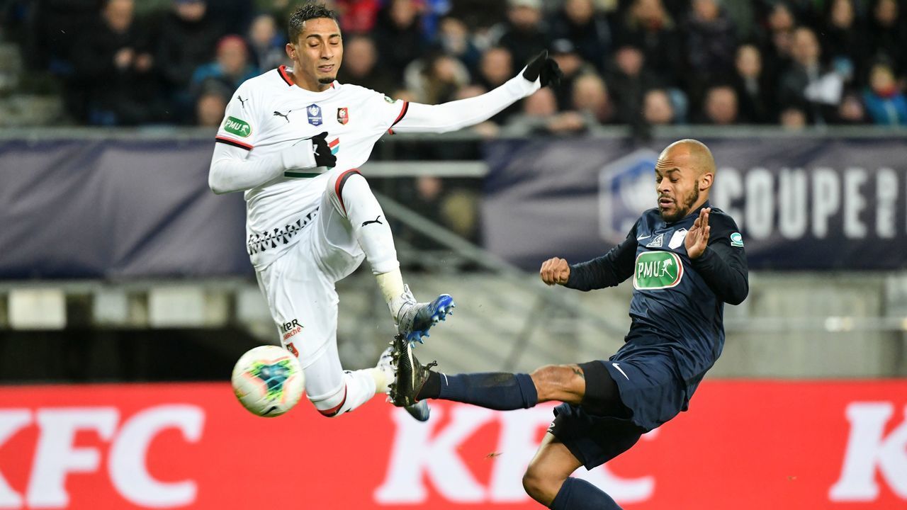 Rennes' Brazilian forward Raphinha (L) scores a goal despite Belfort's French defender Yannick Konki (R) during the French Cup quarter-final football match between Belfort and Rennes at the Auguste Bonal stadium in Montbeliard on February 11, 2020.