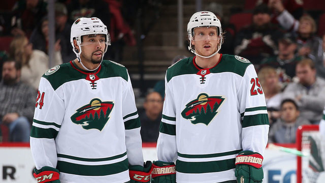 GLENDALE, ARIZONA - DECEMBER 19: Matt Dumba #24 and Jonas Brodin #25 of the Minnesota Wild during the third period of the NHL game against the Arizona Coyotes at Gila River Arena on December 19, 2019 in Glendale, Arizona. The Wild defeated the Coyotes 8-5.
