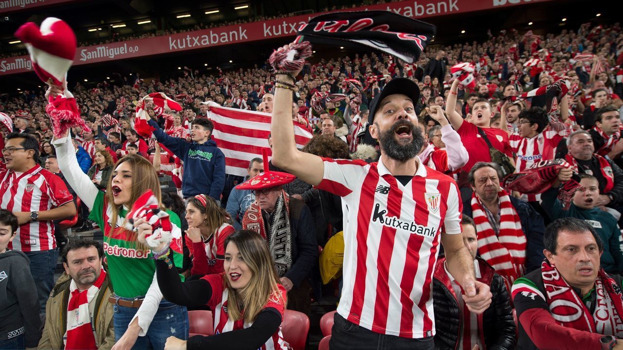 Athletic Bilbao supporters cheer their team during a footall match at San Mames stadium in the Spanish Basque city of Bilbao, on February 12, 2020. - The all-seater football stadium of San Mames in Bilbao, also known as "La Catedral" (The Cathedral), was inaugurated on September 16, 2013, replacing the "old" San Mames as the home of Athletic Club Bilbao football team. The stadium will host four matches during the UEFA Euro 2020 football championship.