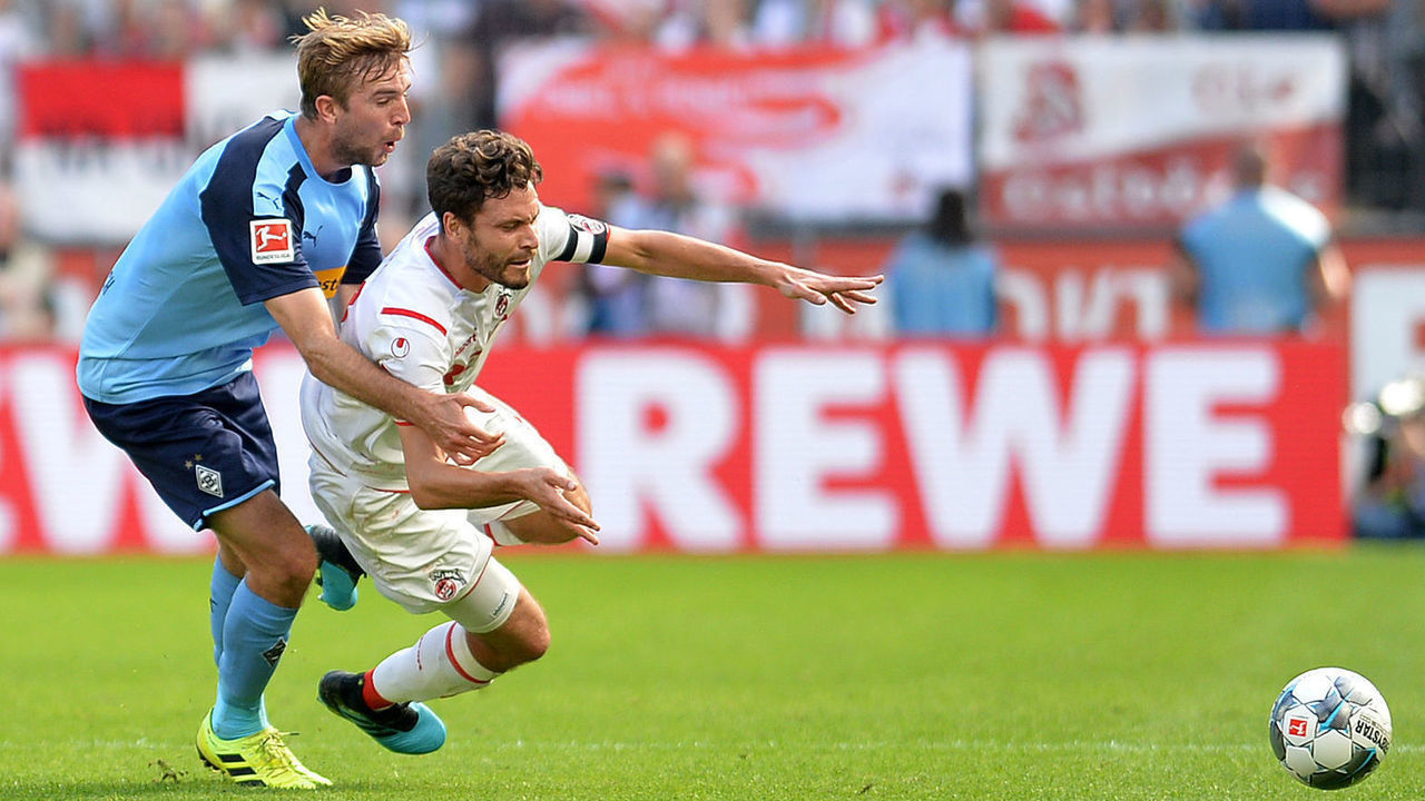 COLOGNE, GERMANY - SEPTEMBER 14: Christoph Kramer of Borussia Moenchengladbach and Jonas Hector of 1. FC Koeln battle for the ball during the Bundesliga match between 1. FC Koeln and Borussia Moenchengladbach at RheinEnergieStadion on September 14, 2019 in Cologne, Germany.