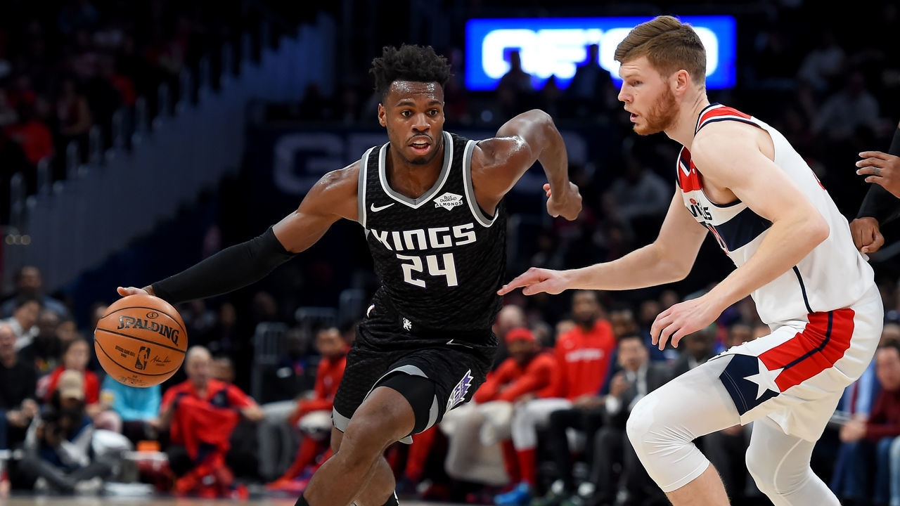 WASHINGTON, DC - NOVEMBER 24: Buddy Hield #24 of the Sacramento Kings dribbles in front of Davis Bertans #42 of the Washington Wizards during the first half at Capital One Arena on November 24, 2019 in Washington, DC.