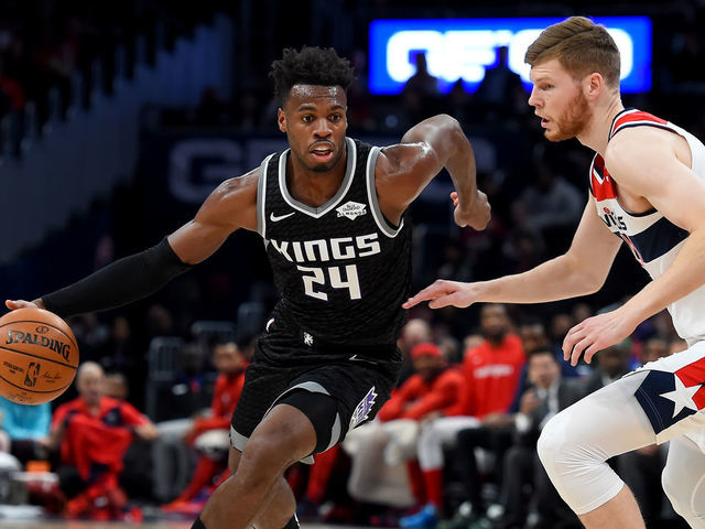 WASHINGTON, DC - NOVEMBER 24: Buddy Hield #24 of the Sacramento Kings dribbles in front of Davis Bertans #42 of the Washington Wizards during the first half at Capital One Arena on November 24, 2019 in Washington, DC.