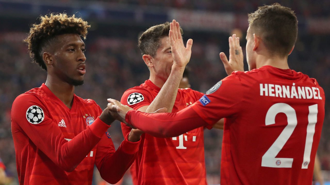 MUNICH, GERMANY - SEPTEMBER 18: Kingsley Coman of FC Bayern Munich celebrates after scoring his team's first goal with Robert Lewandowski and Lucas Hernandez of FC Bayern Munich during the UEFA Champions League group B match between Bayern Muenchen and Crvena Zvezda at Allianz Arena on September 18, 2019 in Munich, Germany.